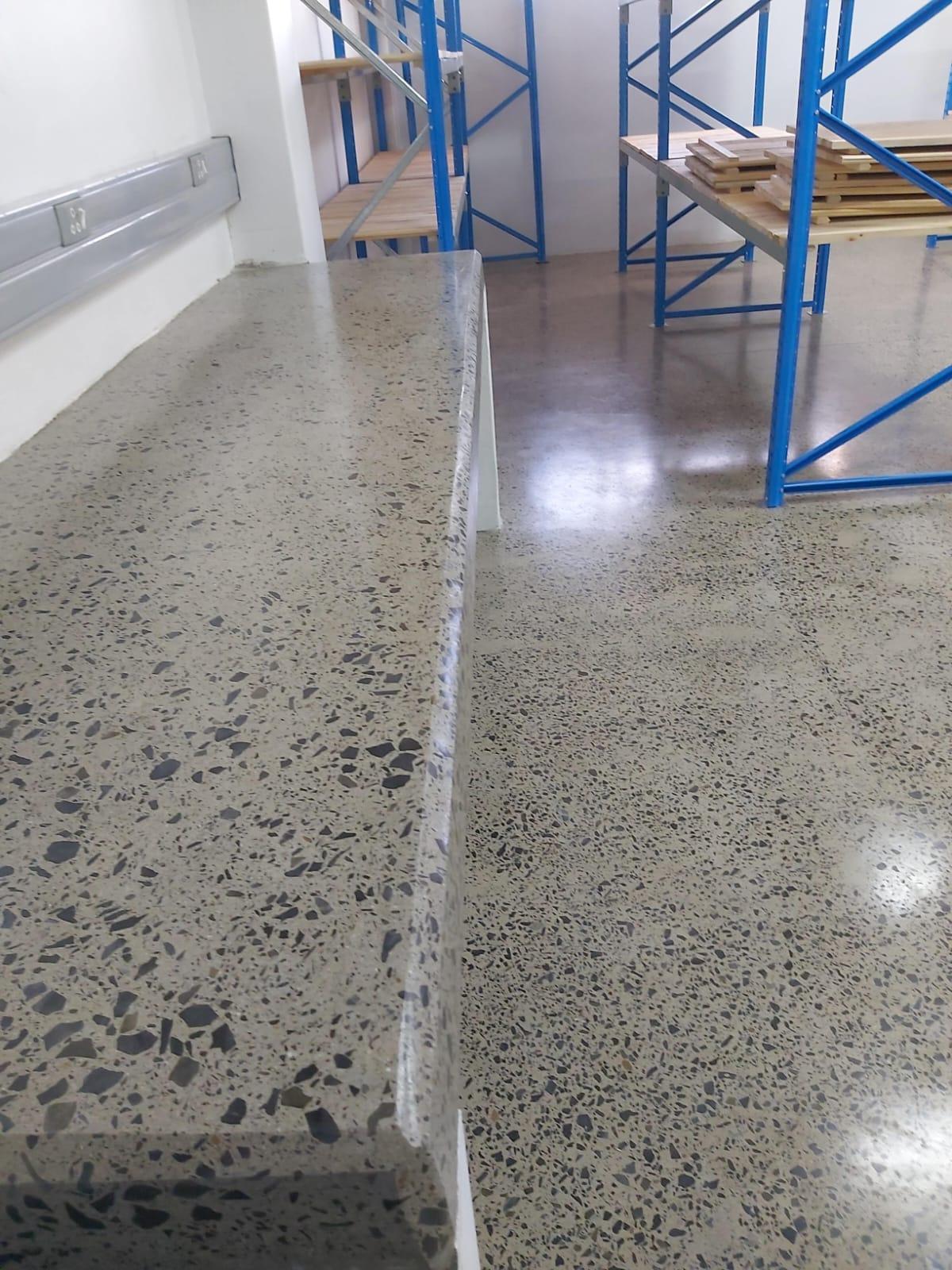 Concrete floor being ground and prepared during renovation